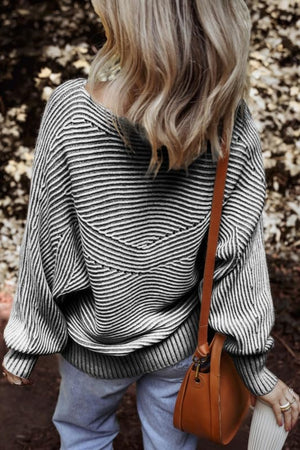 Textured stripe batwing sweater in black and gray with a relaxed fit and dolman sleeves.