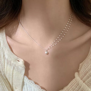 Lustrous pearl pendant layered necklace in 925 sterling silver with delicate draped chains.