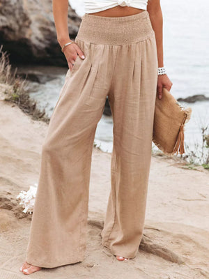 Tan smocked waist wide-leg maternity pants with pleats and pockets