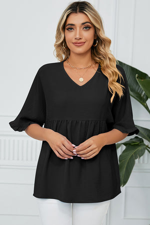 Black gathered yoke blouse with flutter sleeves and v-neckline.