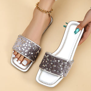 Silver sequined open-toe slide sandals with a comfortable square toe.