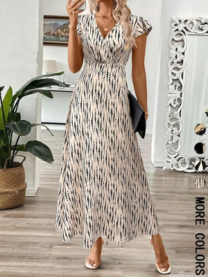 Floral print midi dress with cap sleeves and a V-neck in apricot with black abstract pattern.