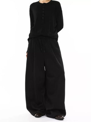 Men's black wide-leg drawstring sweatpants with a relaxed fit.
