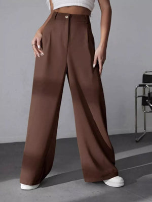 Brown high-waisted pleated wide-leg maternity trousers with button closure.