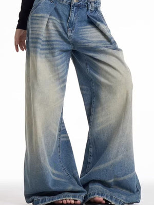 Men's wide leg blue washed jeans with a baggy fit and gradient fade detail.