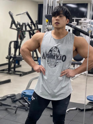 Gray graphic muscle tank top with a circular logo on the chest.