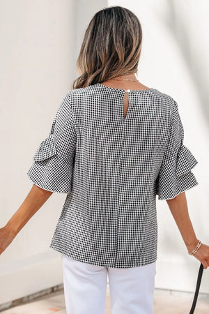Black and white gingham shirt with ruffled sleeves and a keyhole back closure.