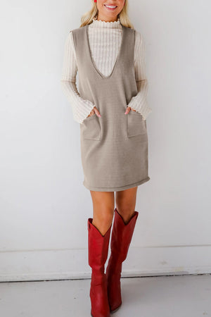 Sleeveless knit dress in gray with V-neck and two front pockets.