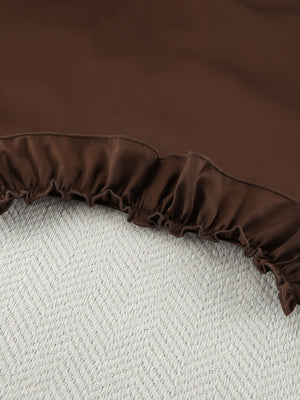 Chocolate ruffled pajama set shorts with elastic waistband and textured background.