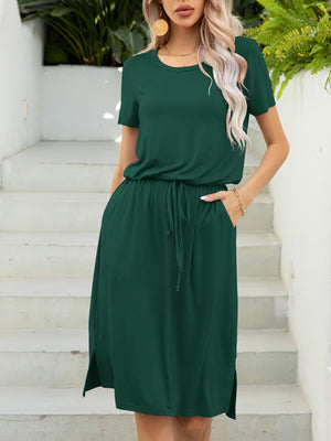 Green midi dress with drawstring waist, short sleeves, pockets, and side slits.