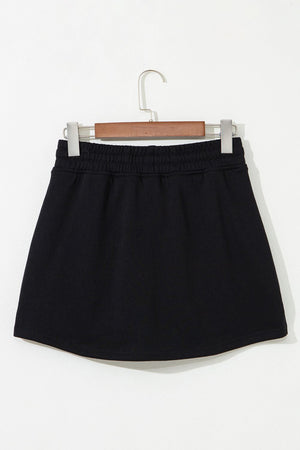 Black French terry skort with drawstring waist and pockets.