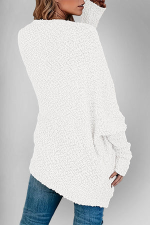 White popcorn knit open cardigan with textured fabric and long sleeves.