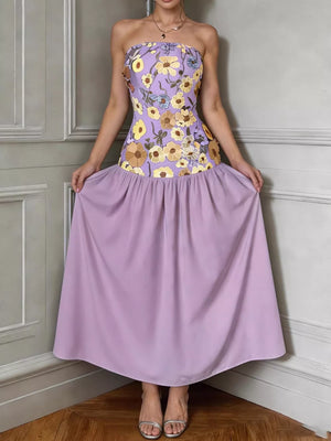 Strapless maxi dress in pink purple with floral embroidery on bodice and flowing skirt.