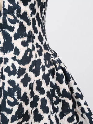 Halter neck leopard print mini dress with a cutout detail.
