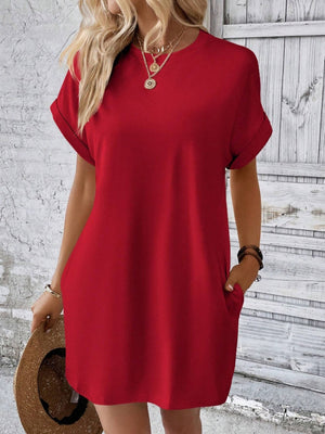 Red relaxed tee dress with cuffed sleeves and pockets, styled casually.