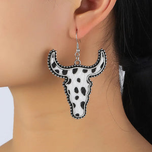 Cow print bull head drop earrings with beaded silver-tone trim.