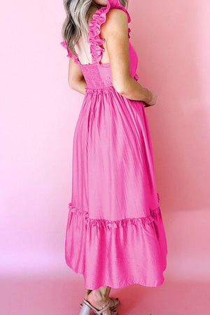 Ruffled sleeveless pink maxi dress with smocked waist and tiered hem.