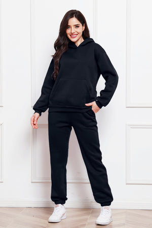 Black relaxed fit hoodie with front pocket and matching joggers.