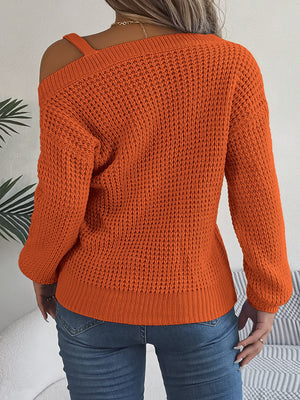 Pumpkin one-shoulder knit sweater with buckle detail and asymmetrical neckline, 100% acrylic.