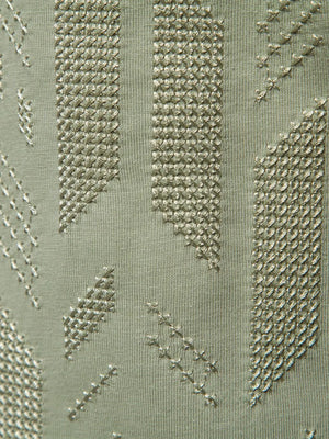 Embossed geometric tee in gum leaf green with textured stitching details.