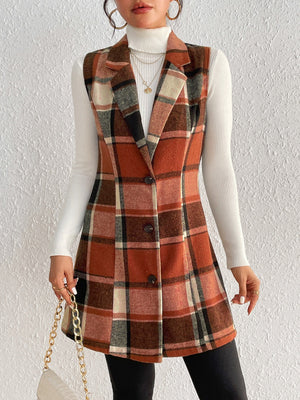 Tailored plaid sleeveless blazer dress in caramel tones, buttoned A-line cut, worn over a white turtleneck.