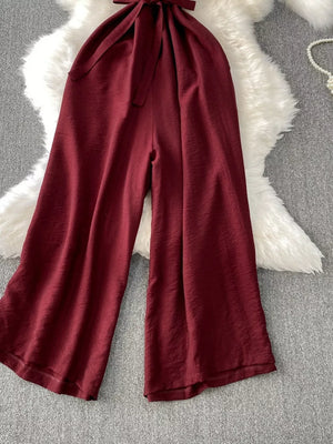 Burgundy V-neck wide leg jumpsuit with tie belt detail
