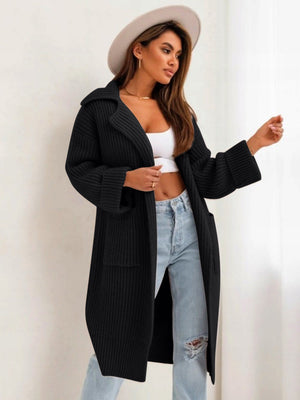 Black oversized knit lapel cardigan with pockets and wide sleeves.