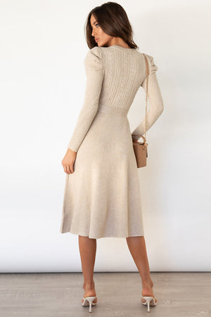 Beige cable knit midi dress with puff sleeves and self-tie belt.