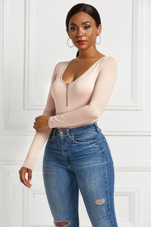 Dusty Pink long sleeve bodysuit with plunge neckline and zip front, styled with jeans.