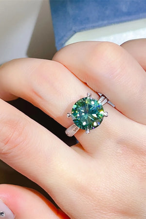 Verdant moissanite solitaire ring with silver band detail on finger