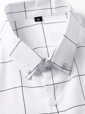 White cotton oversized button-down shirt with black plaid print and button collar.