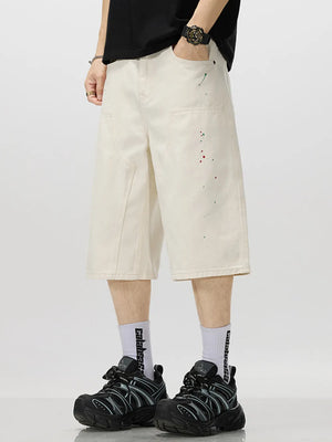 Cream cotton denim capris for him with artistic paint splatter detail.