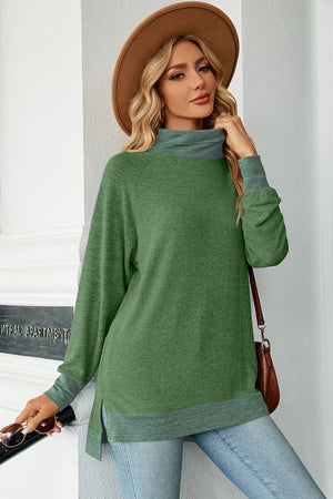 Colorblock raglan turtleneck tunic in green with grey accents, side slits, and a relaxed fit.