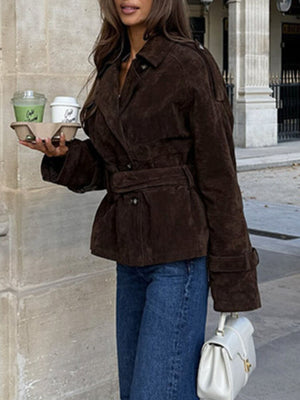 Brown suede trench coat with lapel collar, tie waist, and cropped length.