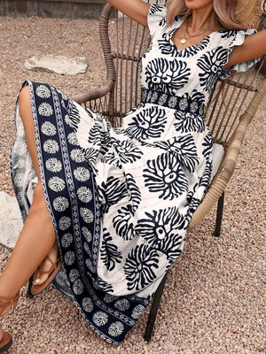 Botanical print maxi dress with V-neck, cap sleeves, and border print detail.