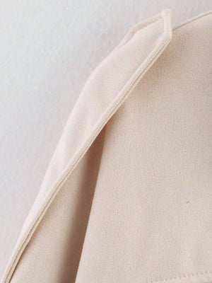 Oversized zip-up jacket in off-white with a textured knit fabric and folded collar detail.