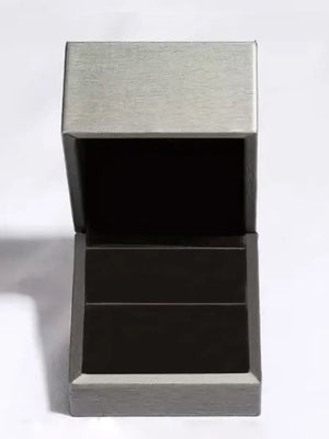 Open ring box with brushed silver lid and dark gray base.