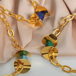 Geometric malachite pendant necklace with 18K gold-plated chain and blue and green stones.