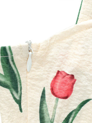 Cream midi dress with red tulip print and side zipper detail.