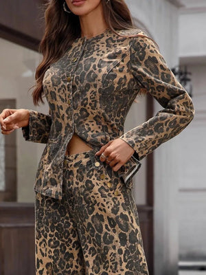 Sleek leopard print denim bolero jacket with button-up front and collarless neckline.