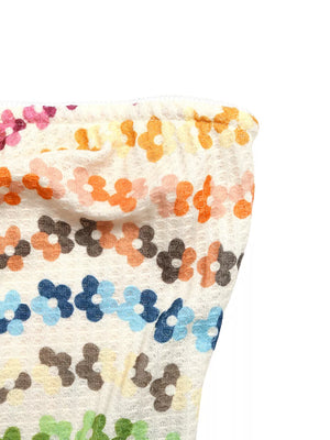 Vibrant floral ruching tank top with a textured knit and colorful daisy pattern.