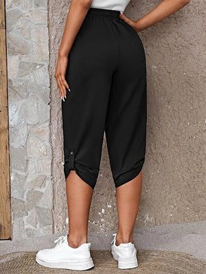 Black culottes with button detail at the hem and a cropped length.