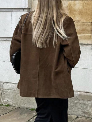 Brown suede blazer with structured shoulders and button detail.