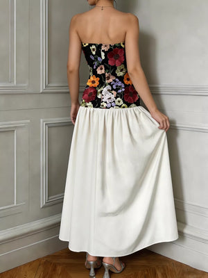 Maxi dress with embroidered floral bodice and white skirt.