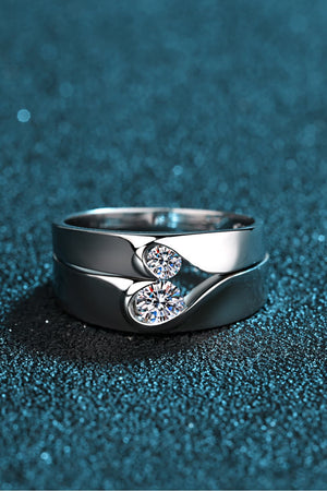 Curved Embrace diamond ring set for men and women, featuring two intertwined silver bands with sparkling cubic zirconia