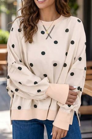 black tunic featuring ribbed cuffs and polka dot