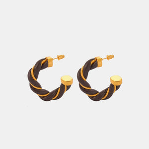 Braided leather and gold hoop earrings with a twisted design.