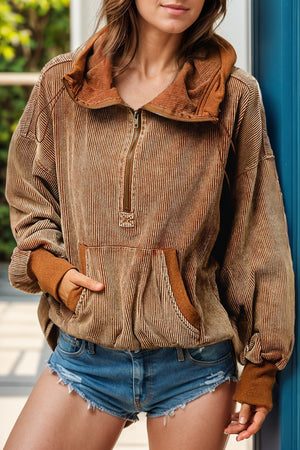 Brown corduroy pullover hoodie with voluminous sleeves and quarter zip.