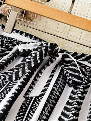 Black and white geometric print maternity pants with a tie bow detail.