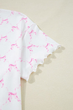 White loungewear top with pink bow print and scalloped lettuce edge sleeves.